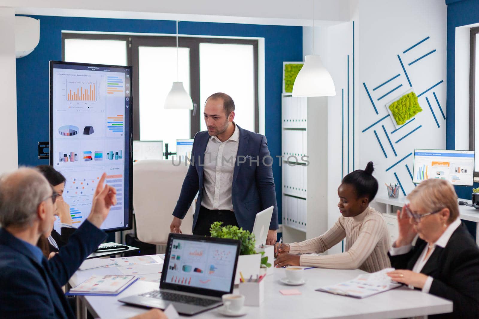 Angry screaming executive corporate in conference meeting room by DCStudio