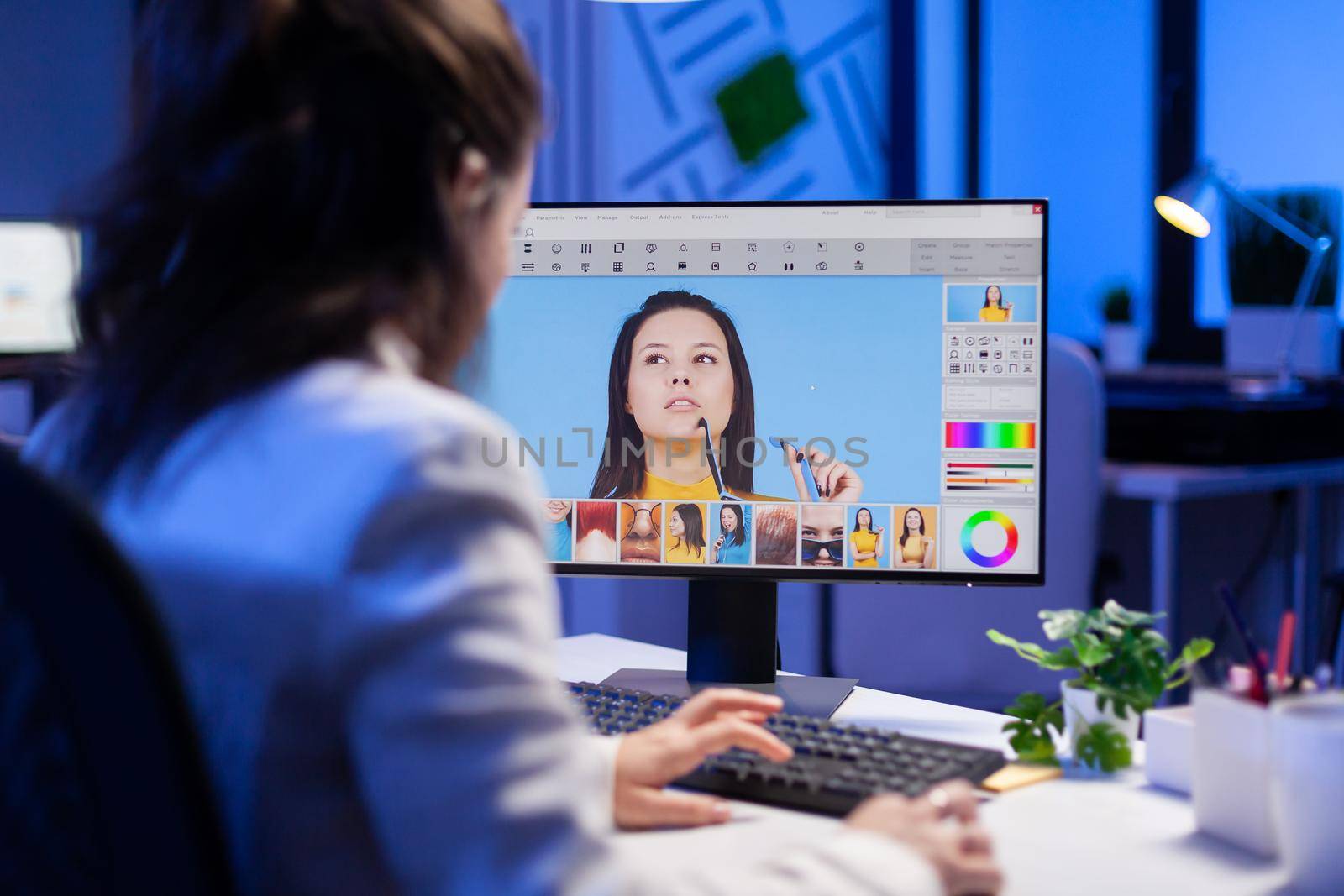 Freelancer retoucher woman working overtime on laptop computer with photo editing software. Graphic editor retouching photos of a client on performance pc before deadline