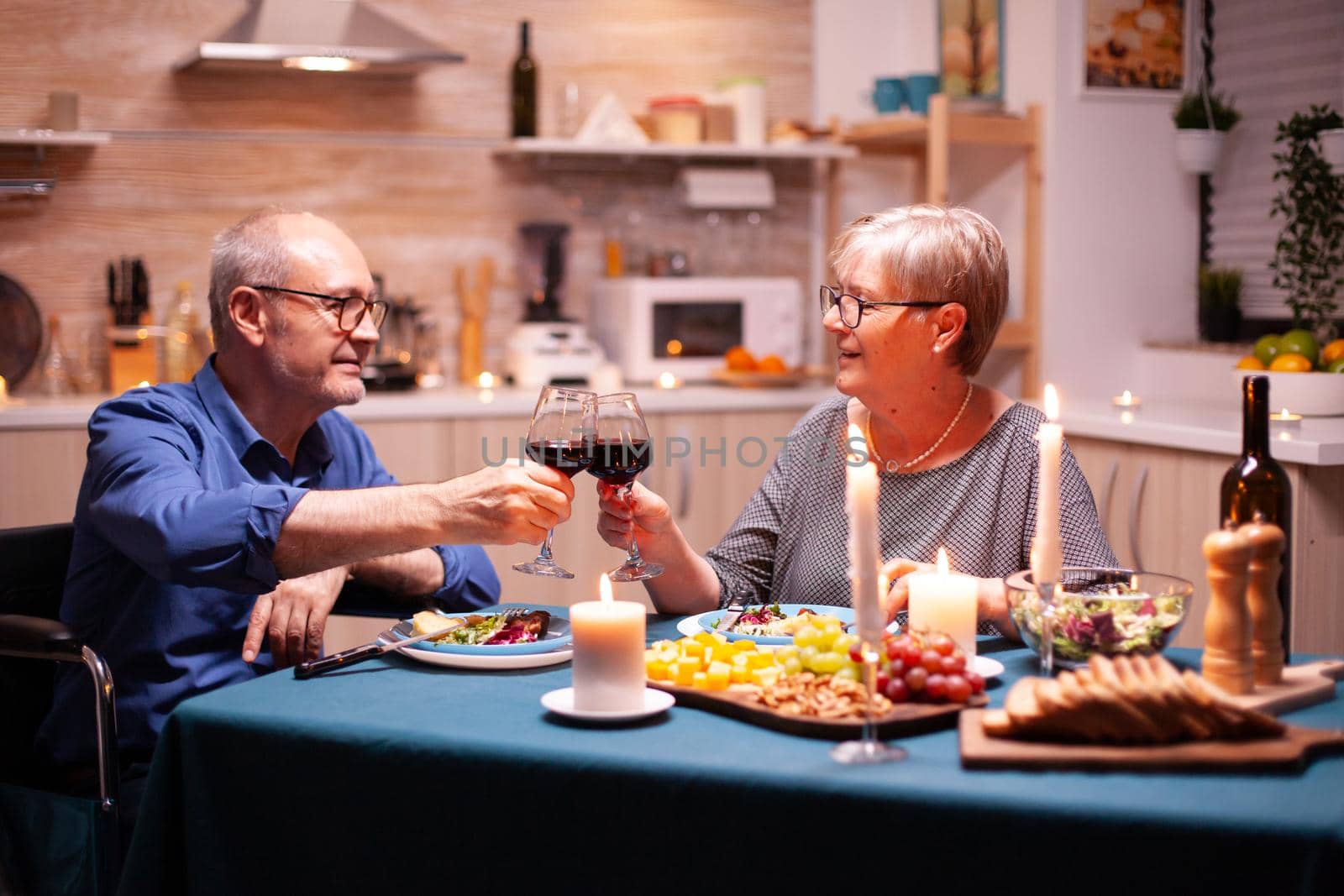 Man in wheelchair dining with wife by DCStudio