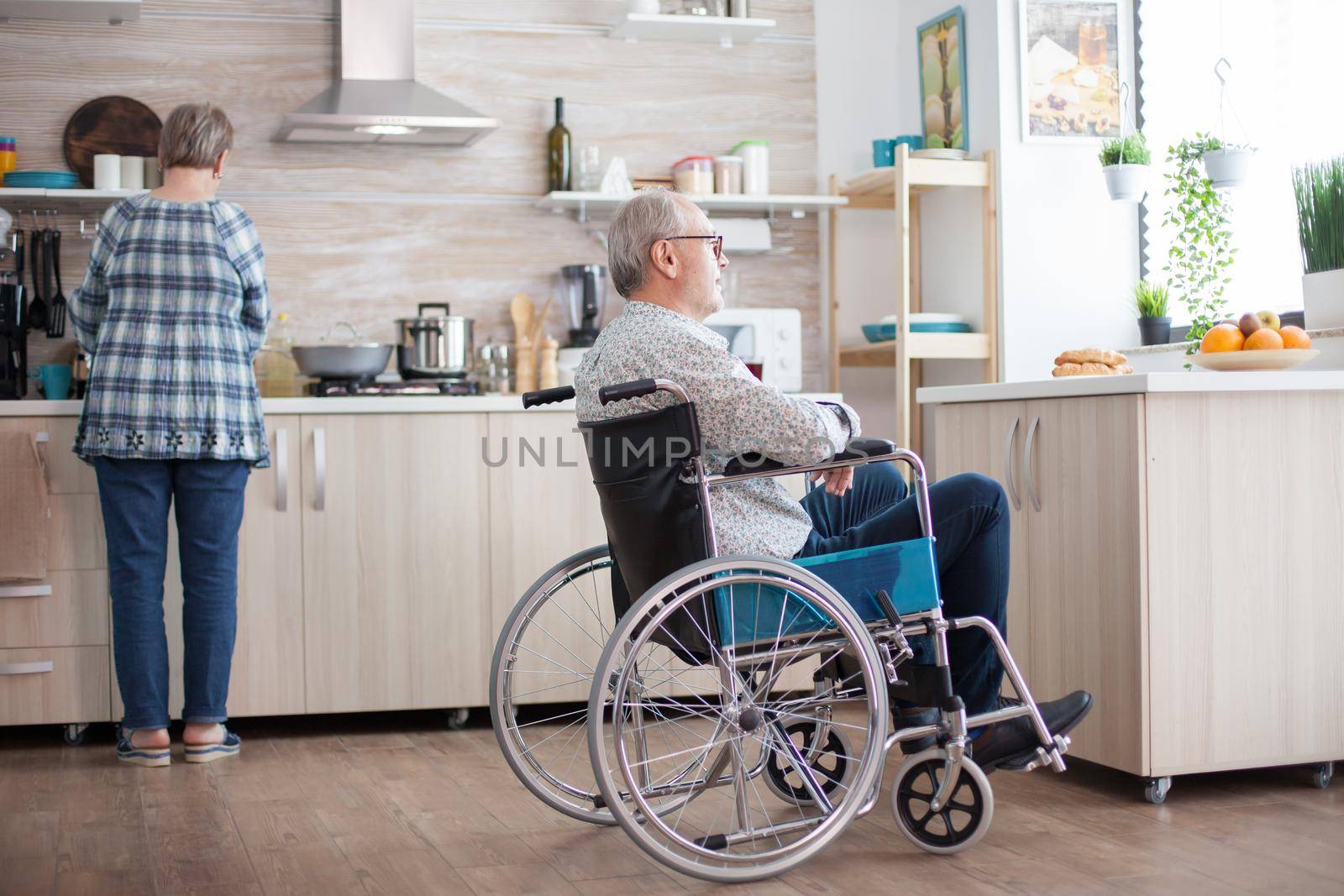 Disabled man sitting in wheelchair by DCStudio