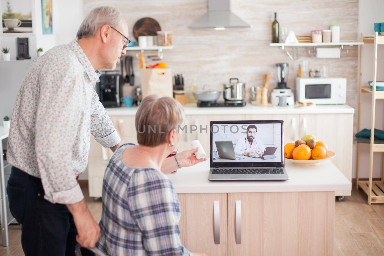 Mature woman talking with doctor by DCStudio