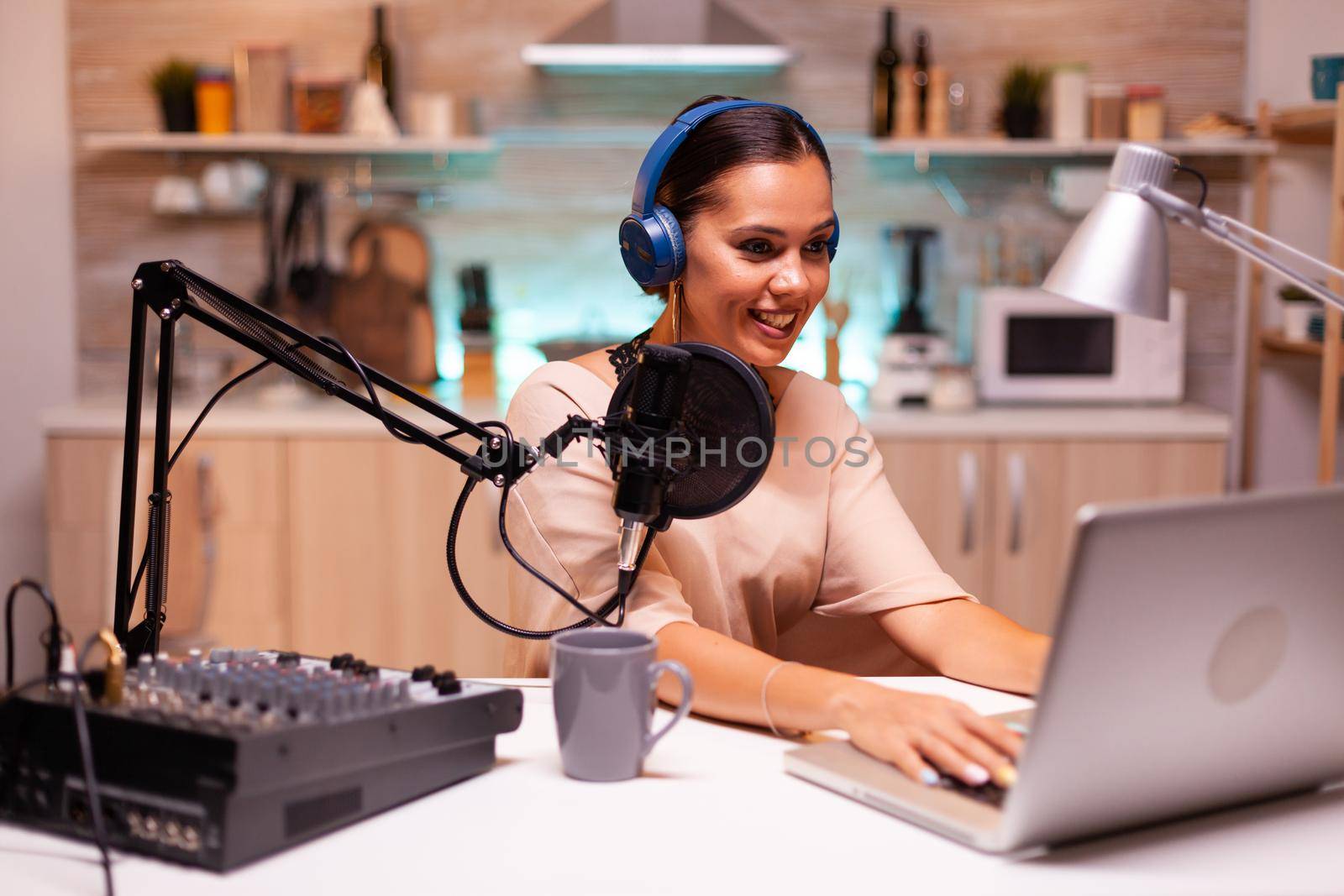 Video blogger reading email and wearing headphones during broadcast. Creative online show On-air production internet broadcast host streaming live content, recording digital social media communication
