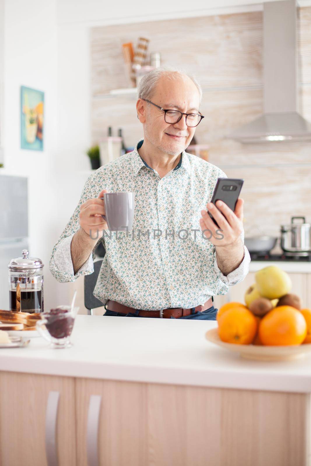 Senior man chatting online by DCStudio