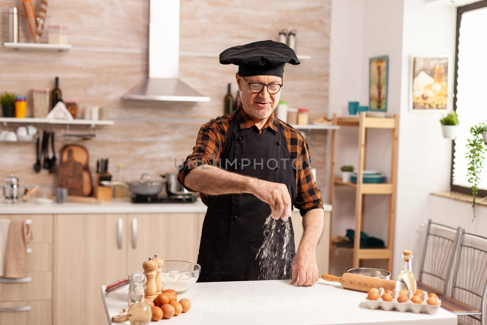 Senior baker preparing bread by DCStudio