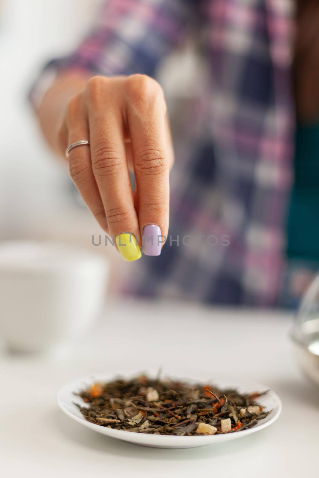 Woman pouring aromatic herbs by DCStudio