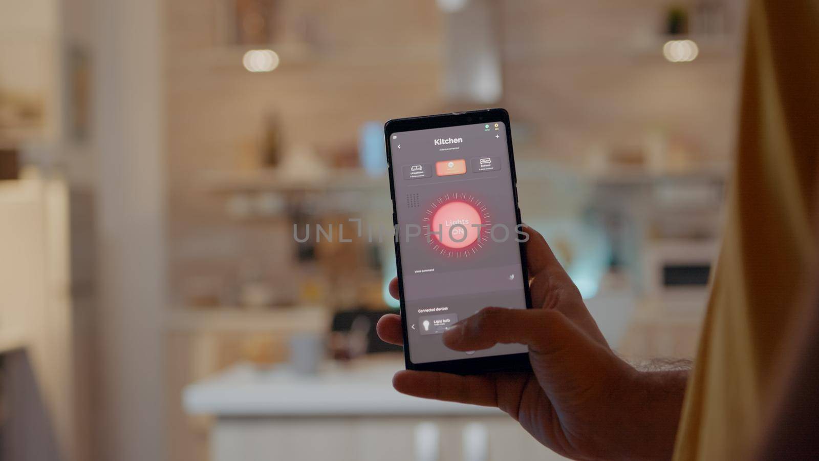 Man using smart home app touching screen to turn on light by phone by DCStudio