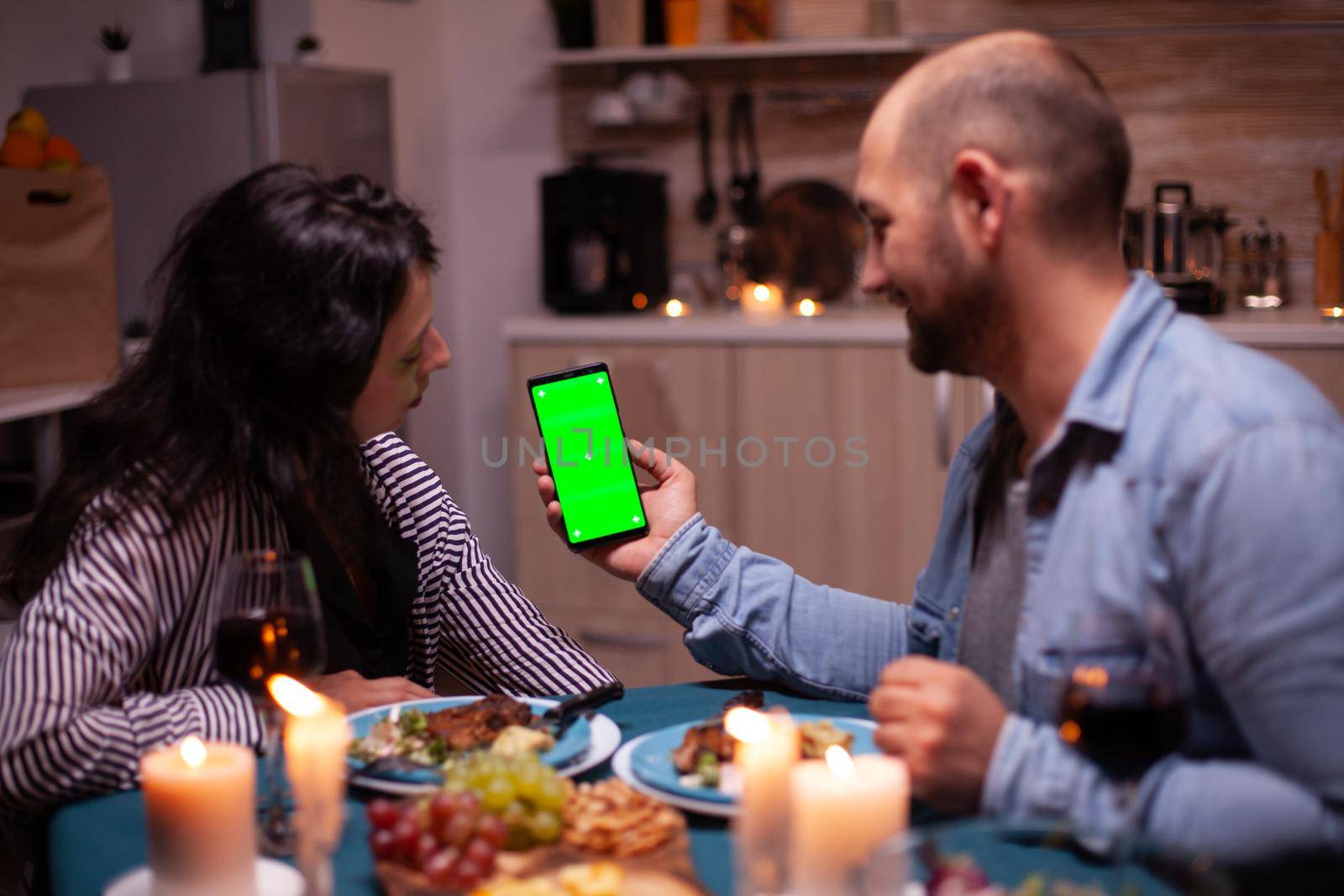 Couple watching phone with green screen by DCStudio