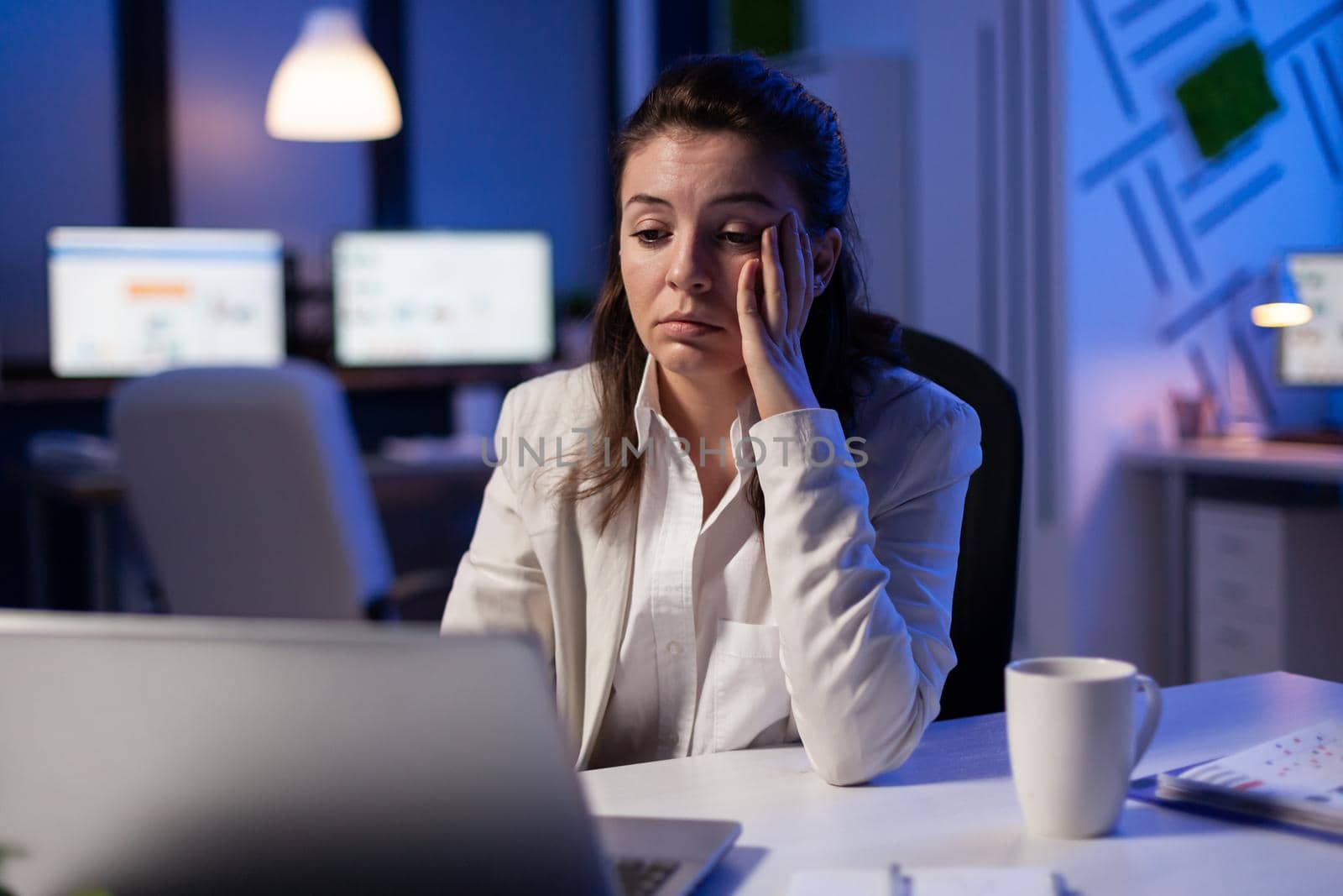 Tired woman fall asleep checking financial analyze late at night in start-up business office. Exhausted manager planning new project with teamates using modern technology network