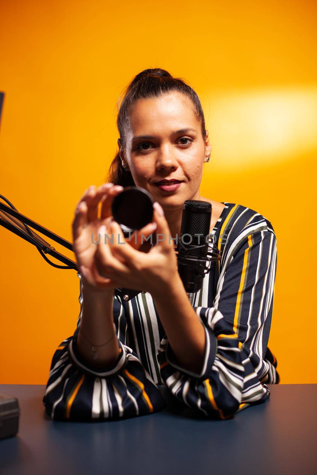 Photographer using nd filter while recording professional podcast. New media star influencer on social media talking video photo equipment for online internet web show