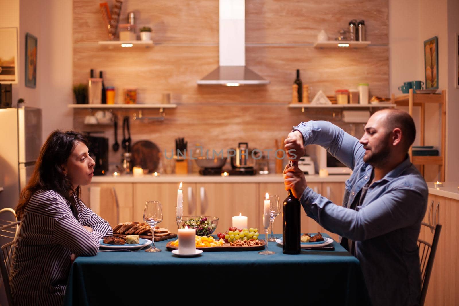 Husband opens wine bottle by DCStudio