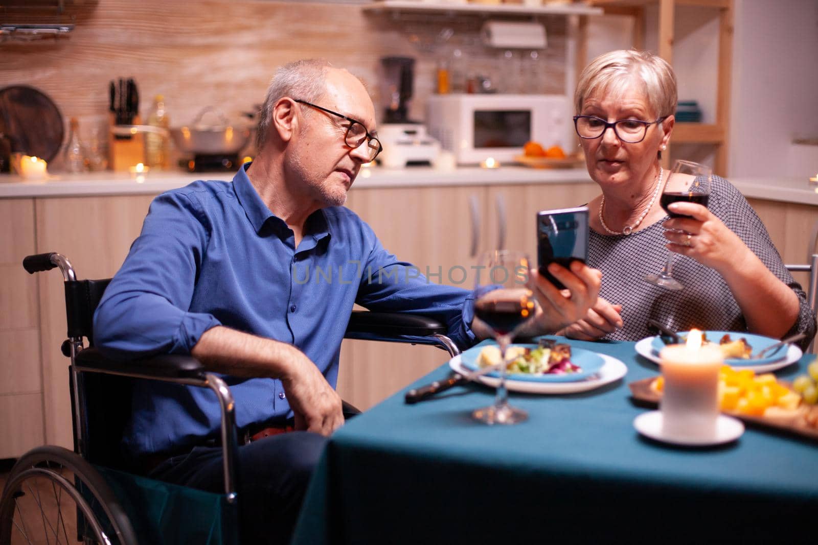 Disabled man using smartphone by DCStudio