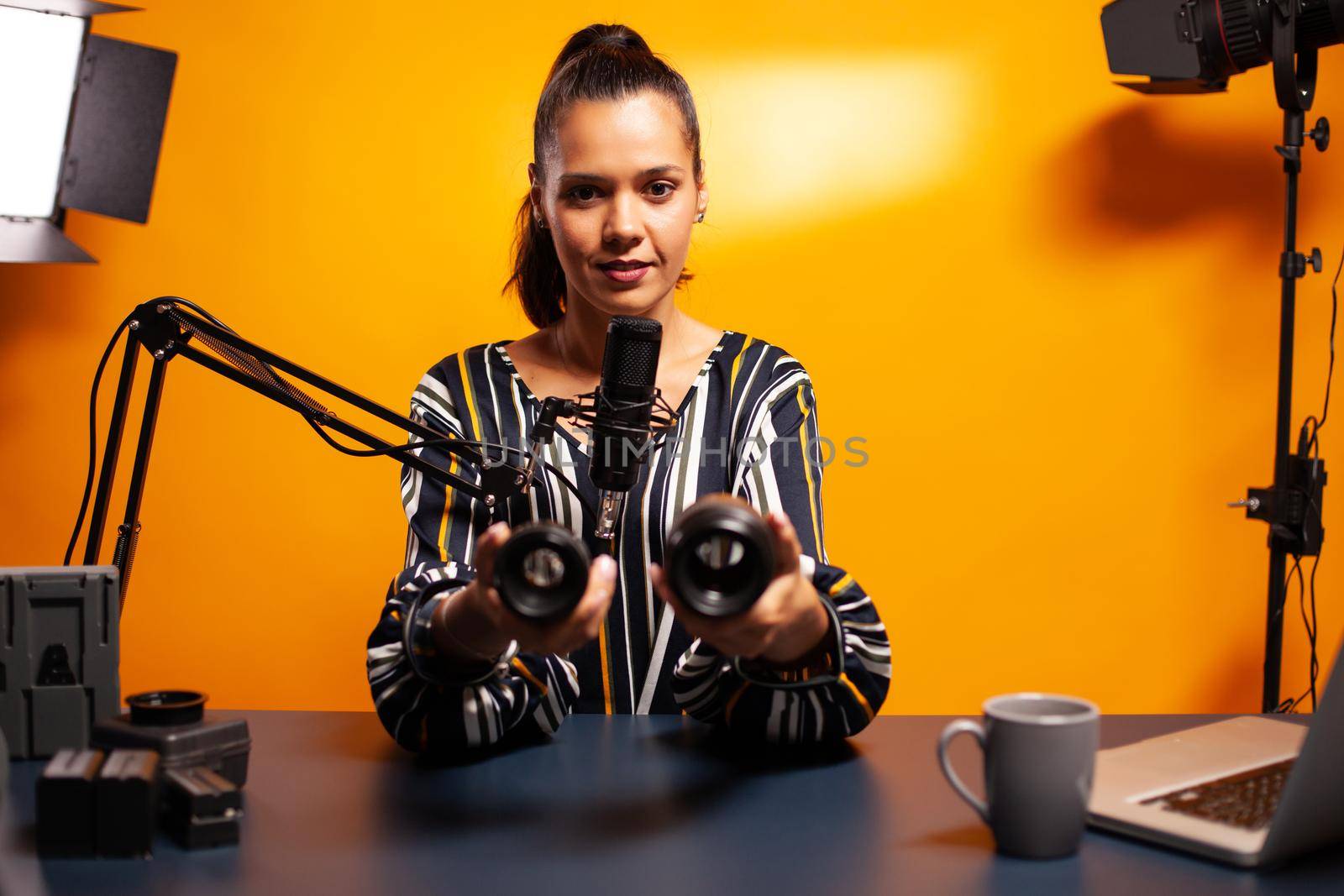 Vloger looking at camera lens while recording podcast. New media star influencer on social media talking video photo equipment for online internet web show.