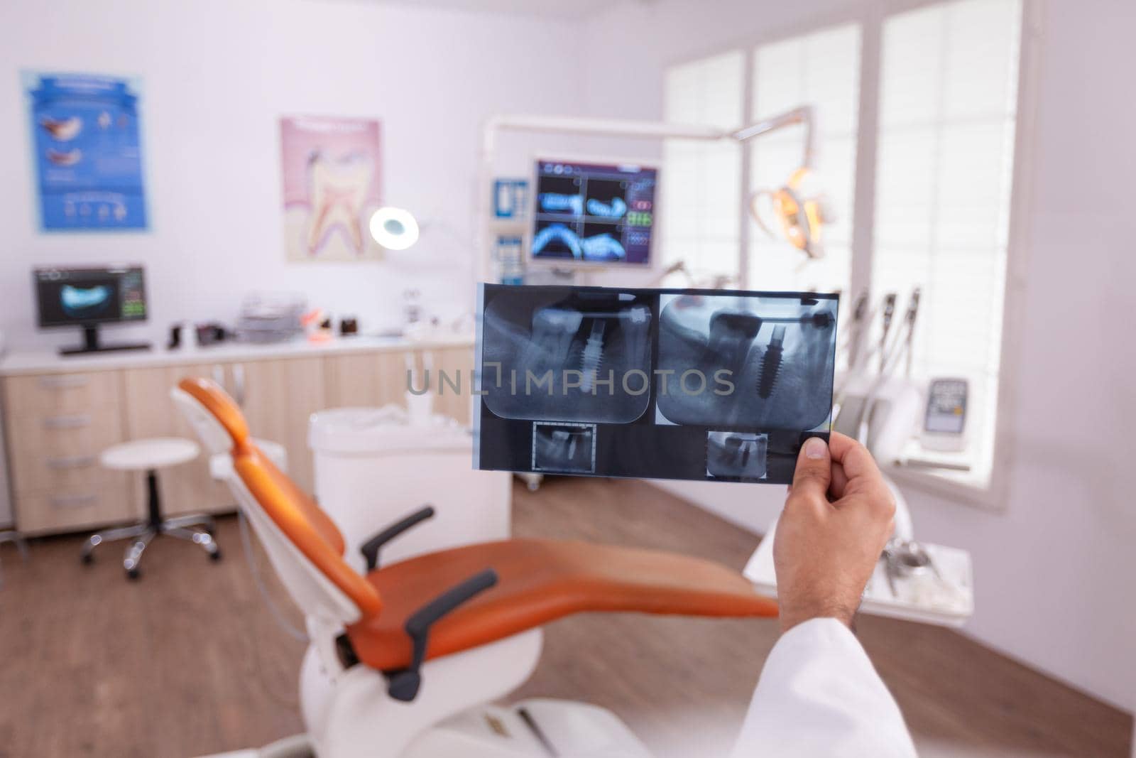 Orthodontist radiologist analyzing teeth jaw radiography working at healthcare treatment by DCStudio