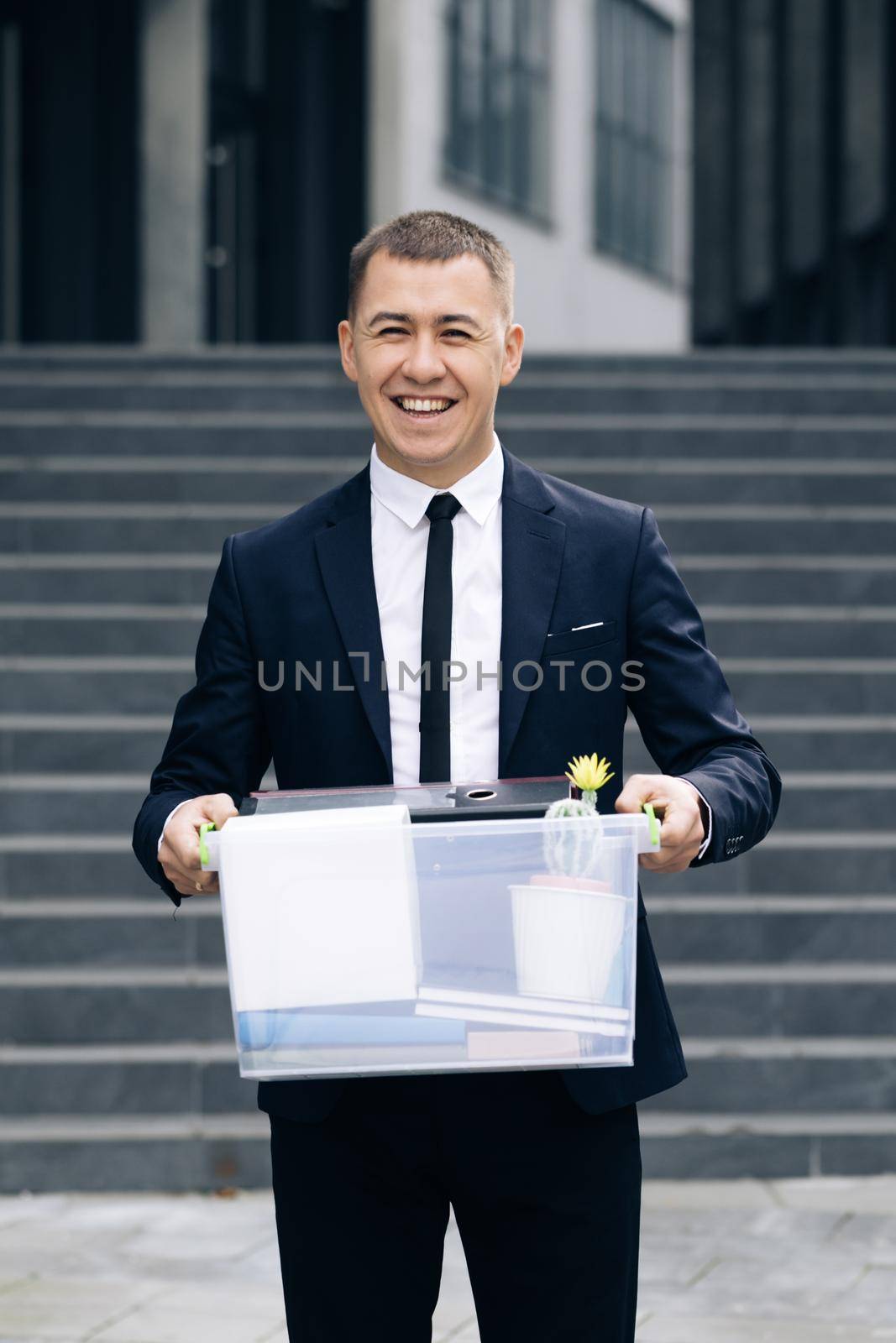 Male office worker with box of personal stuff resigns from his job. Concept of dismissal from work, recruitment by uflypro