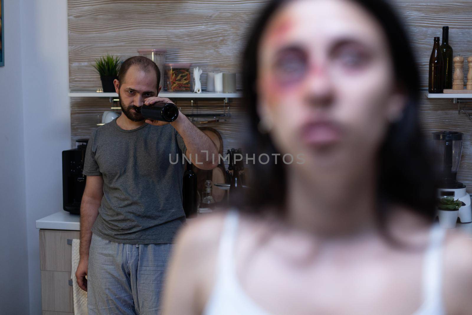 Violent man drinking alcohol from bottle having addiction by DCStudio