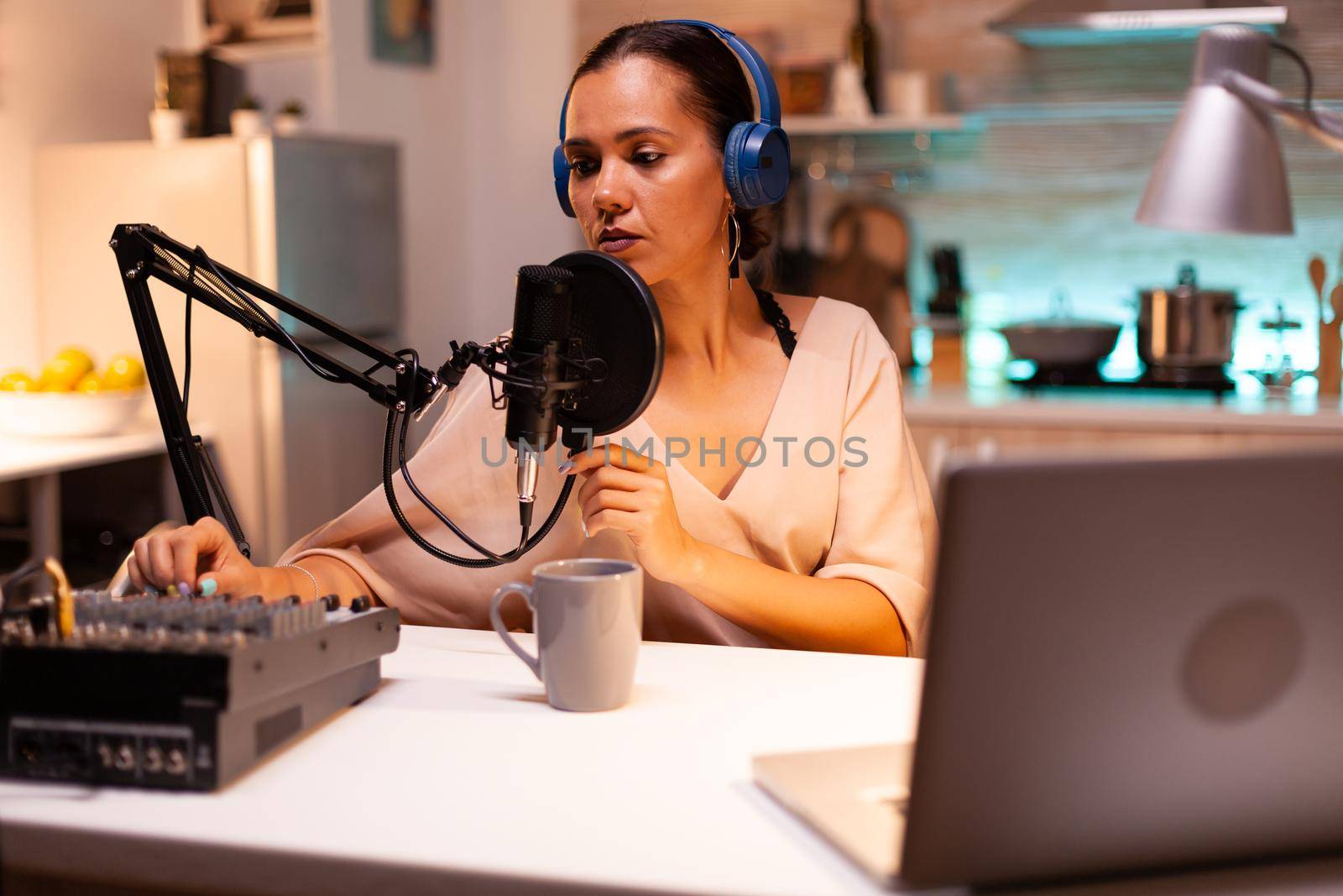 Influencer wearing headphones recording new podcast series for her audience. On-air online production internet broadcast show host streaming live content, recording digital social media communication