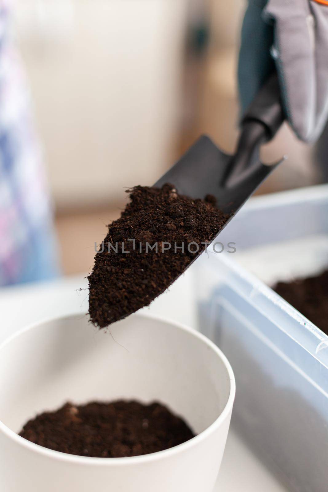 Holding shovel with fertil soil by DCStudio