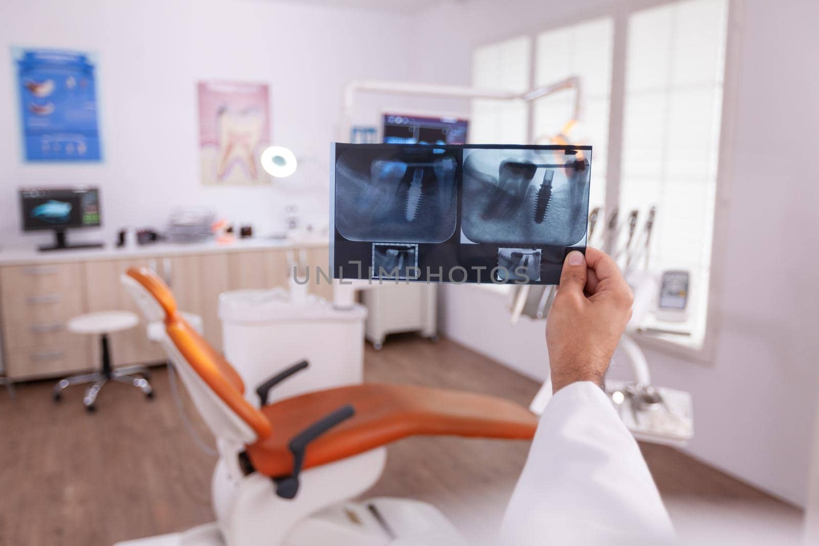 Orthodontist doctor holding medical teeth jaw radiography examining dental oral healthcare working in stomatology hospital office room. Dentistry xray professional expertise afetr tooth surgery