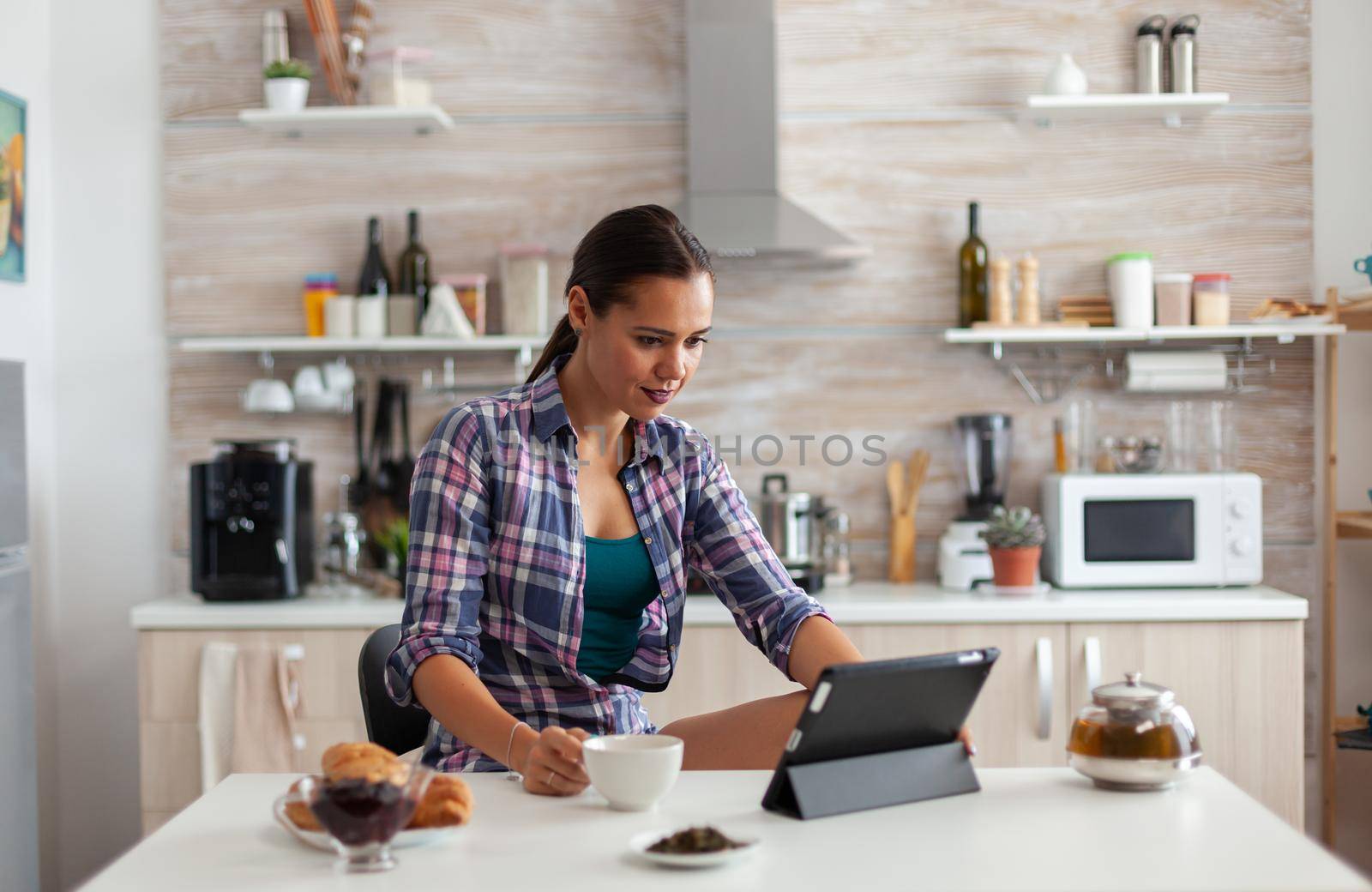 Woman using tablet in the morning by DCStudio