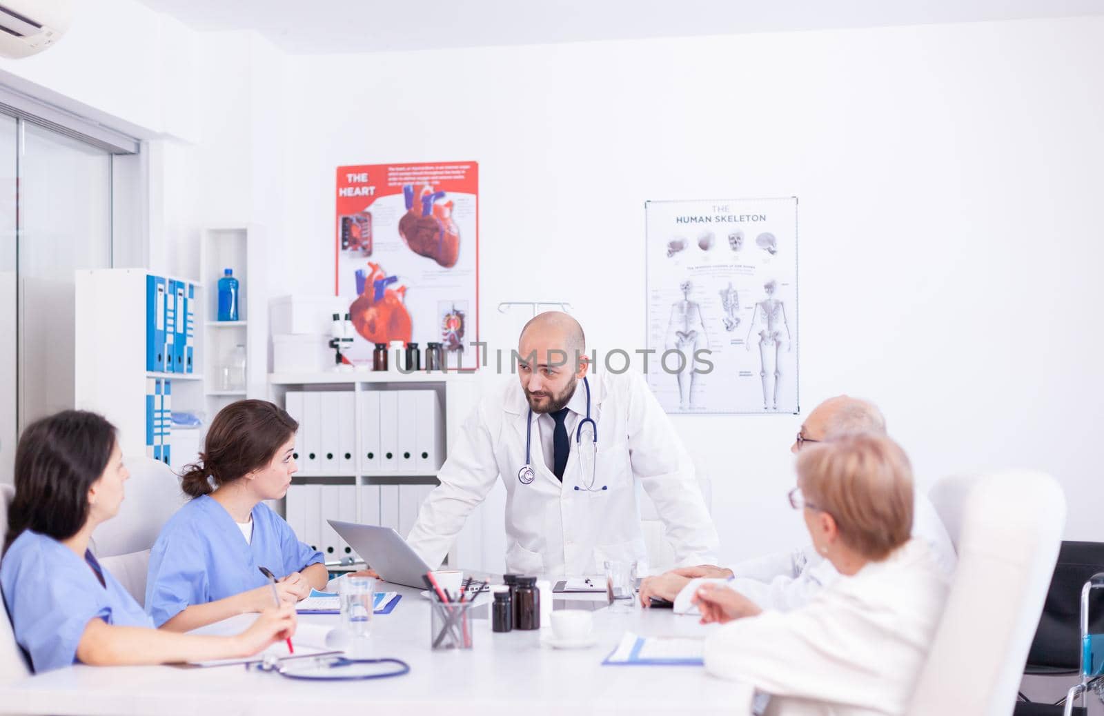 Young medical specialist discussing by DCStudio