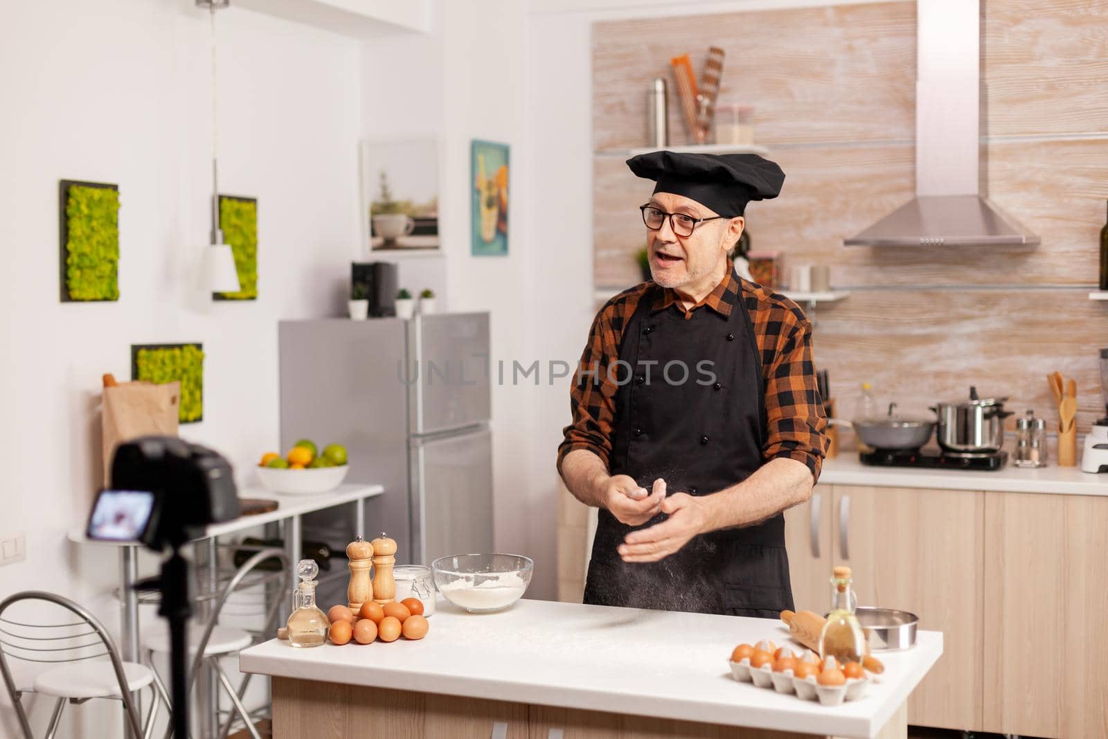 Senior man creating content for culinary blog by DCStudio