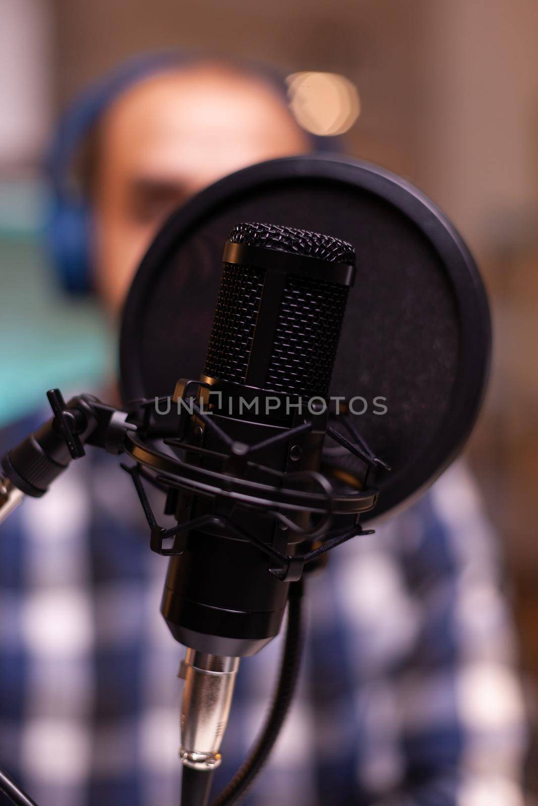 Close up of man speaking at broadcasting microphone. Creative online show On-air production internet broadcast host streaming live content, recording digital social media communication
