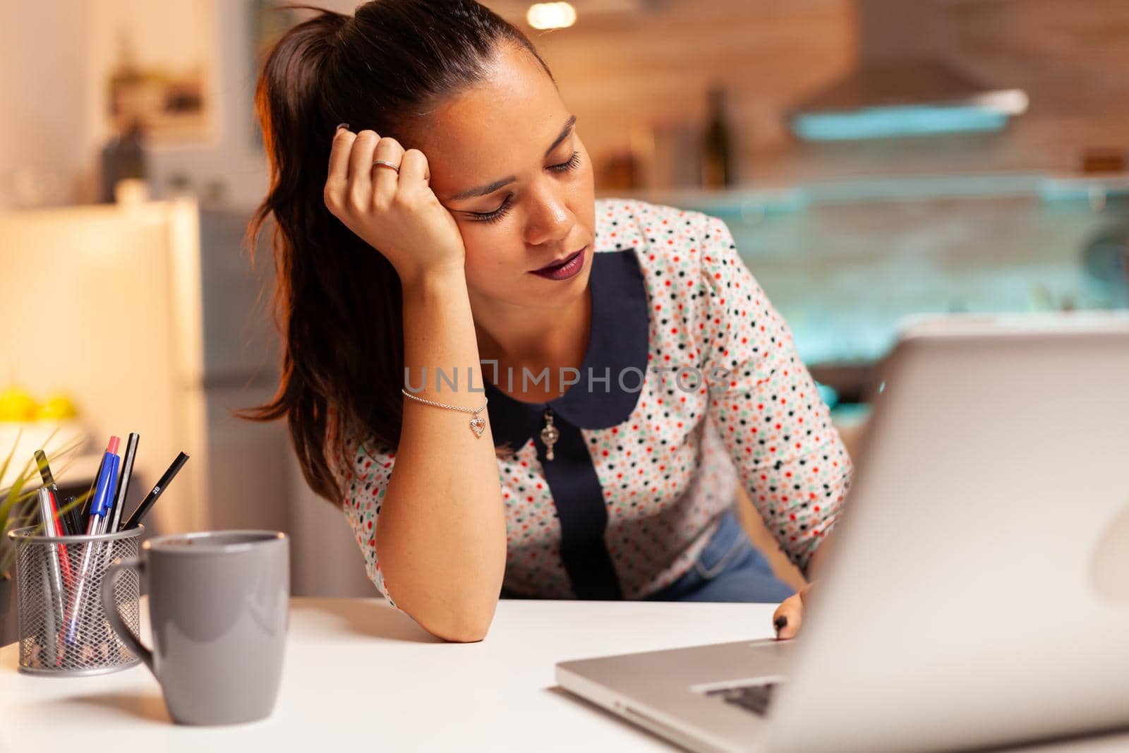 Woman resting eyes while working by DCStudio