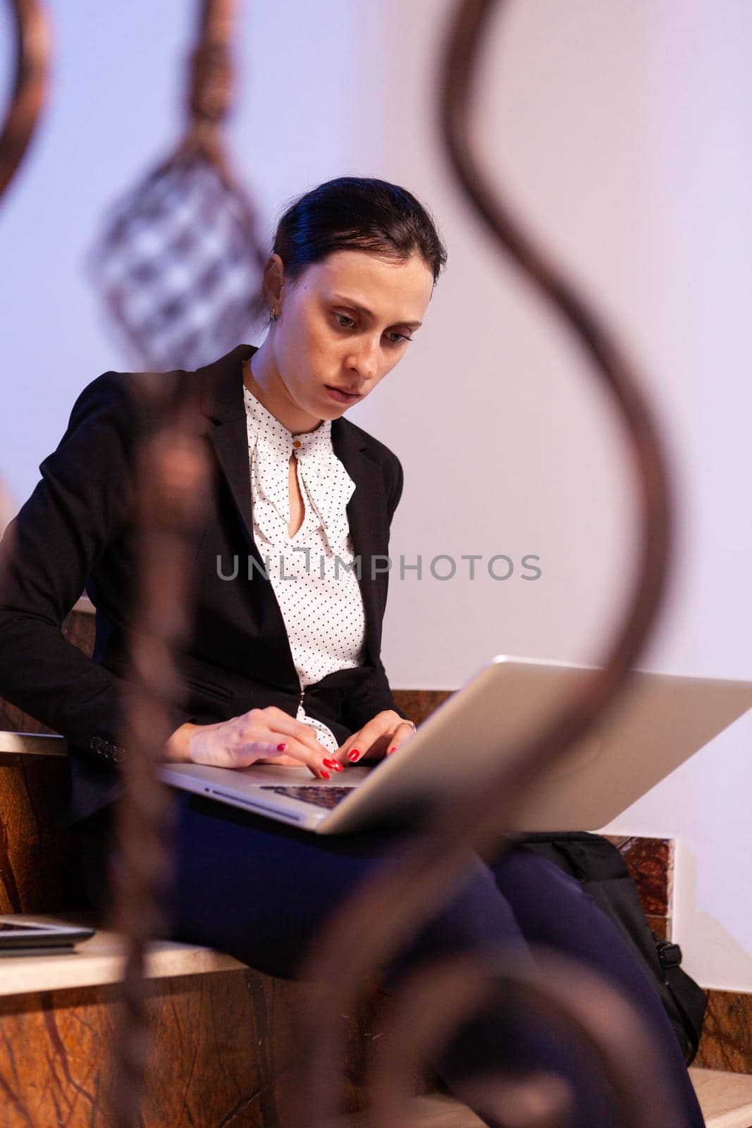 Overworked stressed businesswoman working on business deadline. by DCStudio