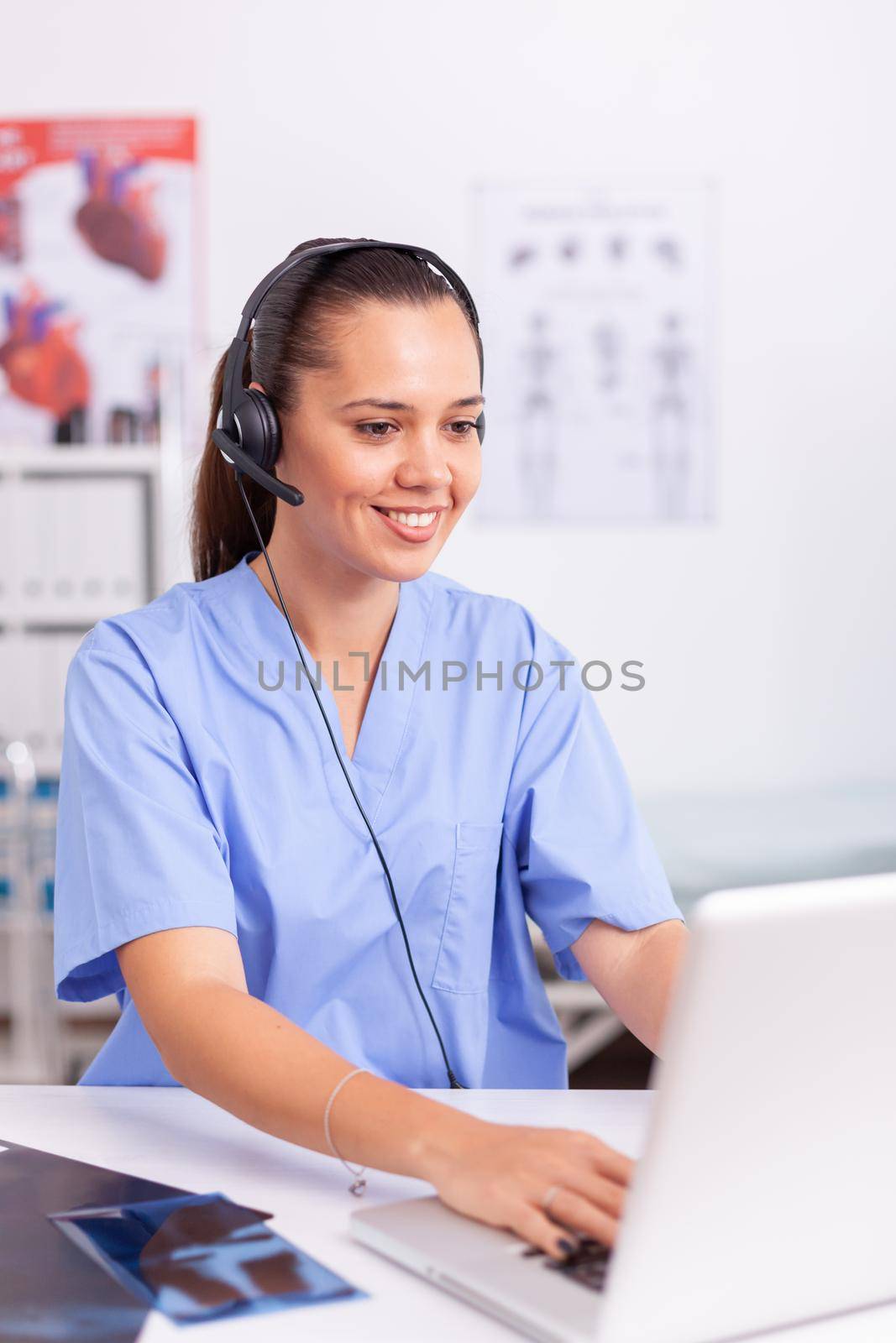 Medical receptionist wearing headset by DCStudio