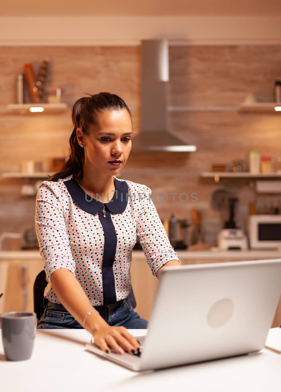 Businesswoman working on computer during a deadline late at night. Employee using modern technology at midnight doing overtime for job, business, busy, career, network, lifestyle ,wireless.