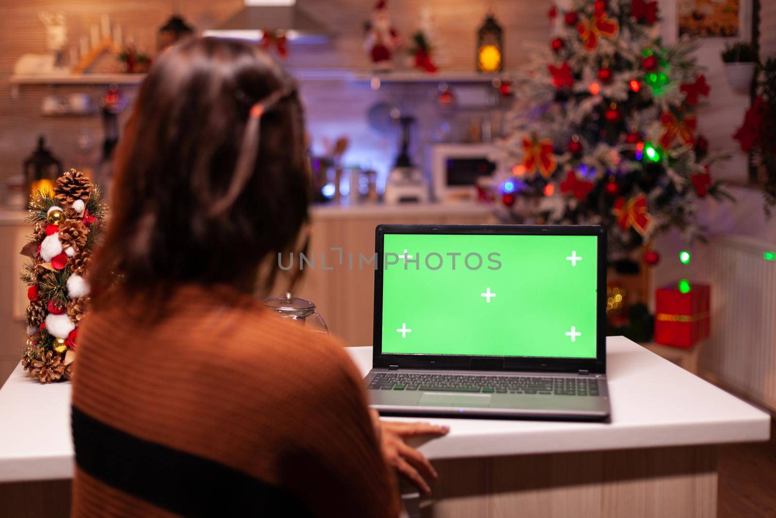 Young adult watching laptop device with green screen by DCStudio