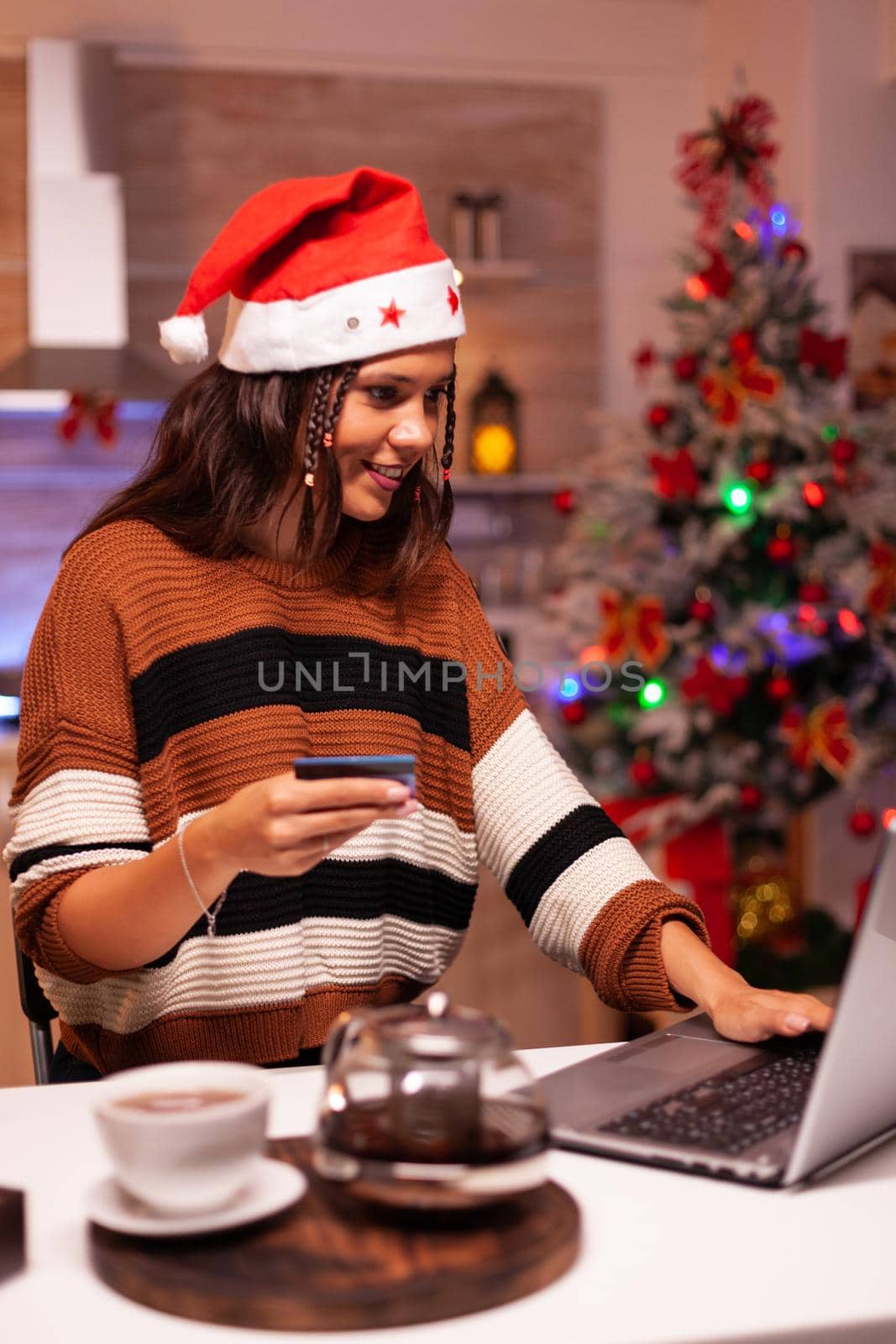 Traditional adult doing online christmas shopping by DCStudio