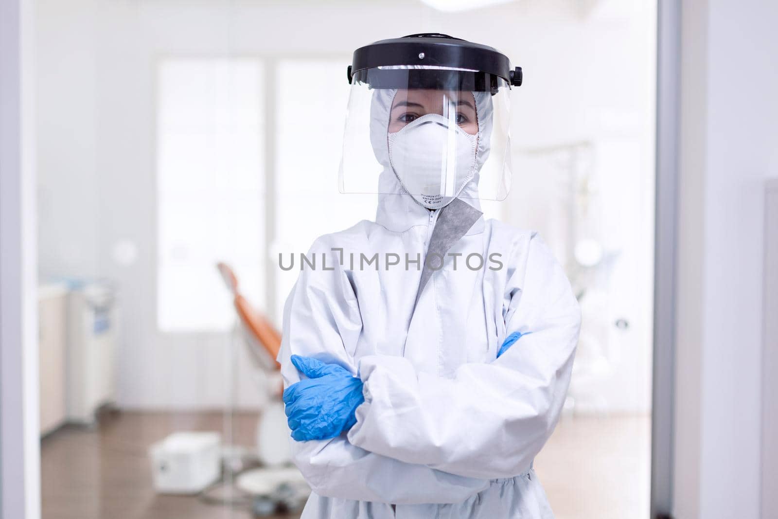 Tired doctor during global outbreak because of population infection with coronavirus. Medical personal dressed in protection equipment against infection with covid-19 during global pandemic.