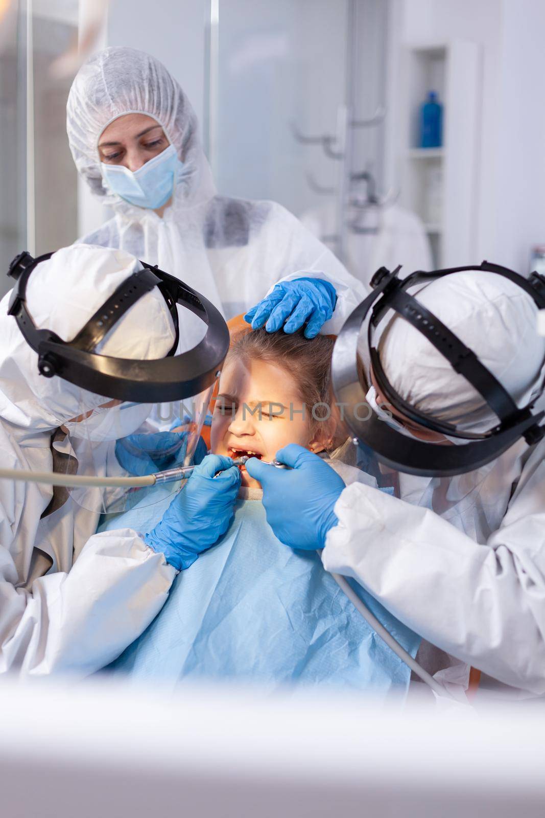 Dentist specialist treating child caries by DCStudio