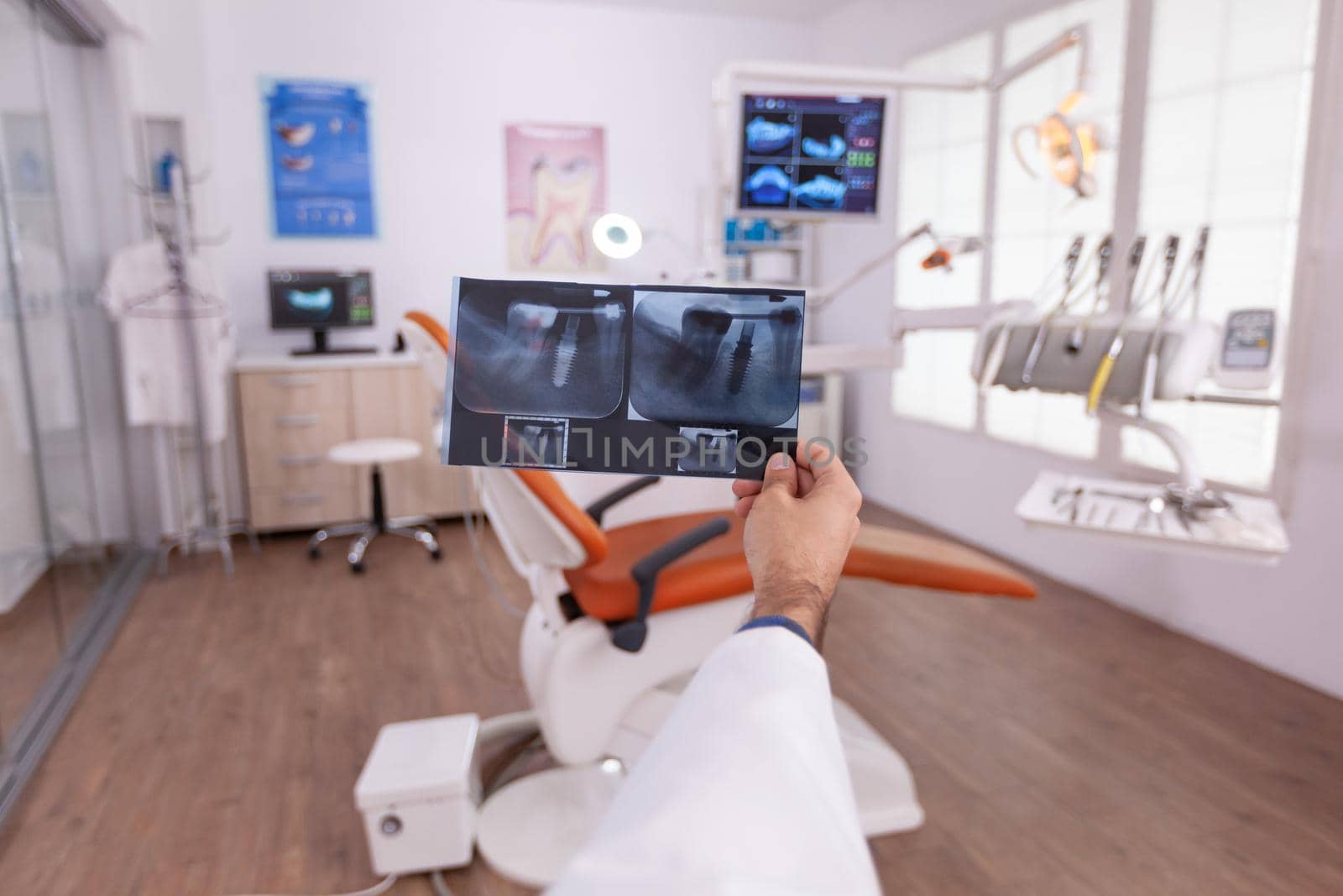Radiologist doctor holding oral dental teeth radiography examining teethcare expertise working in stomatology hospital office. Orthodontist man analyzing surgery diagnosis in examination room