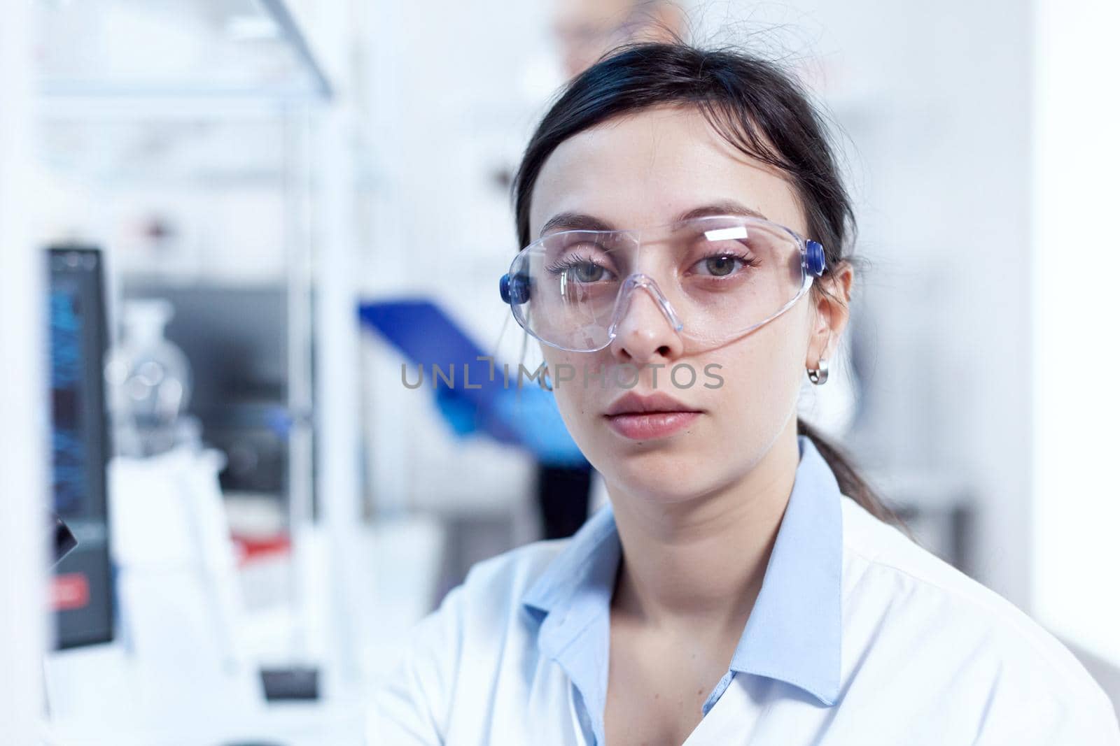 Close up portrait of virus researcher in scientific laboratory by DCStudio
