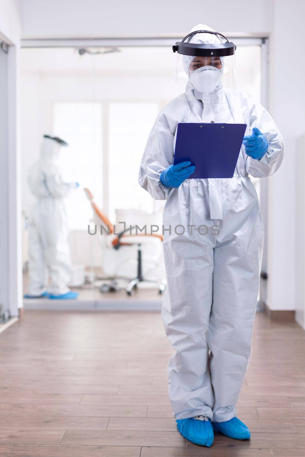 Overworked doctor with suits against contamination with coronavirus by DCStudio