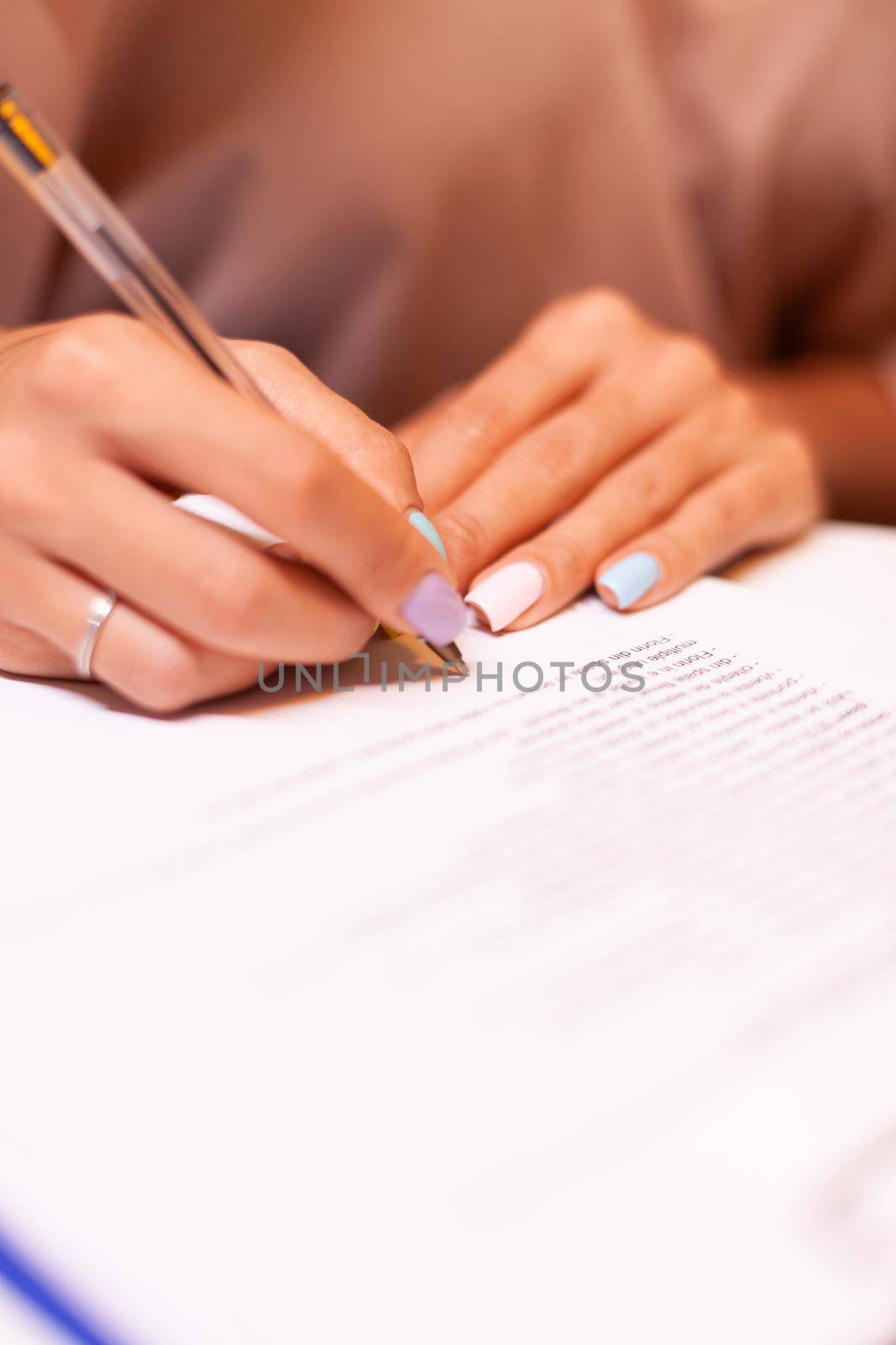 Close up of woman writing by DCStudio