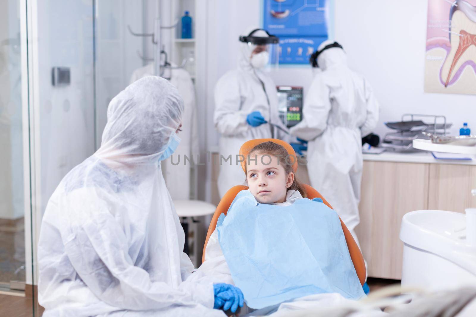 Little girl wearing coverall in dentist office by DCStudio