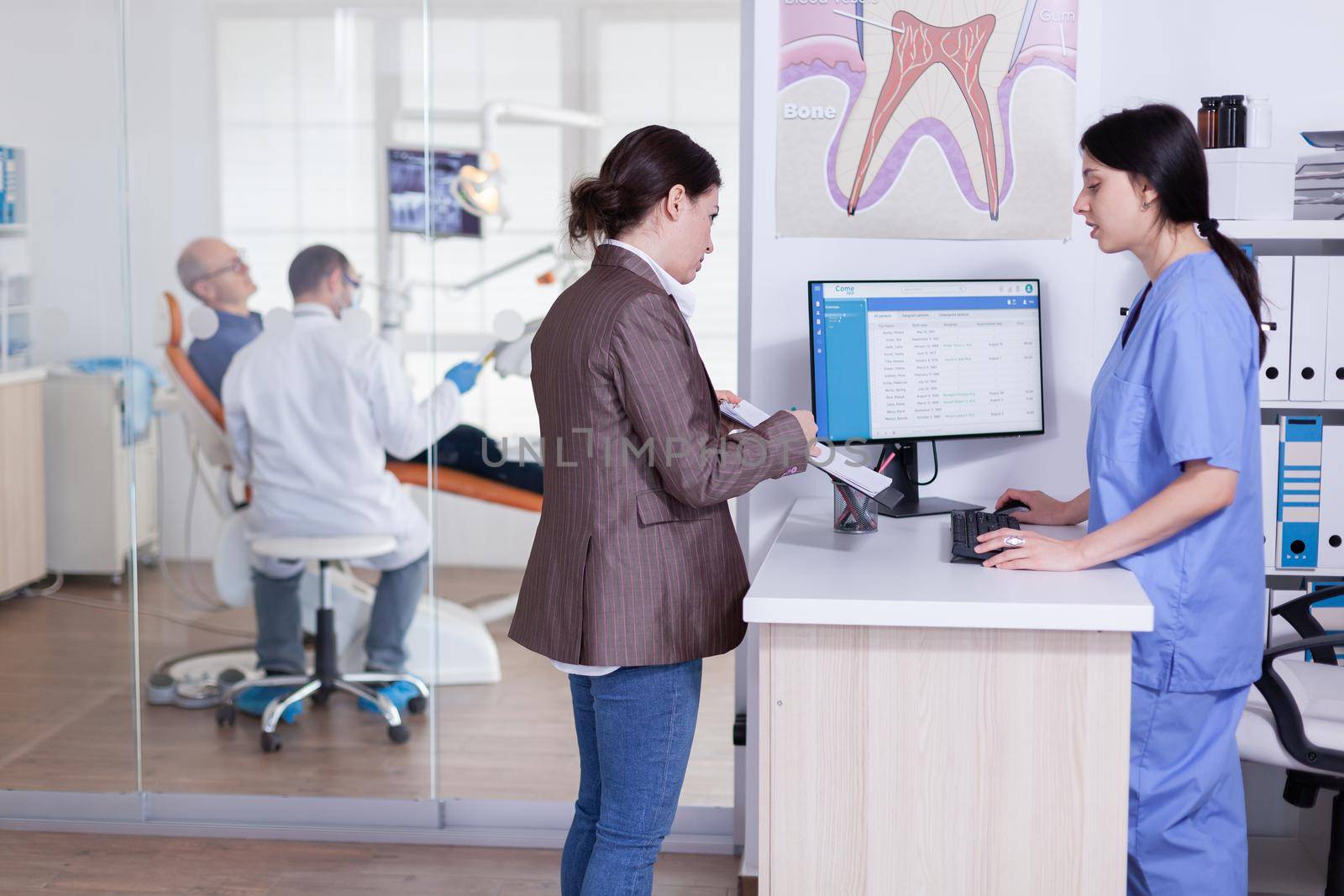 Patients asking informations filling in dental document by DCStudio