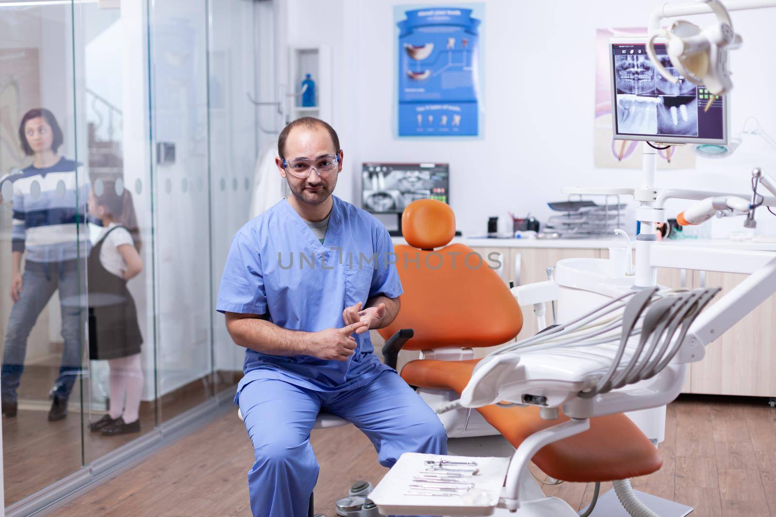 Professional dentist discussing about multiple teeth hygine issues by DCStudio