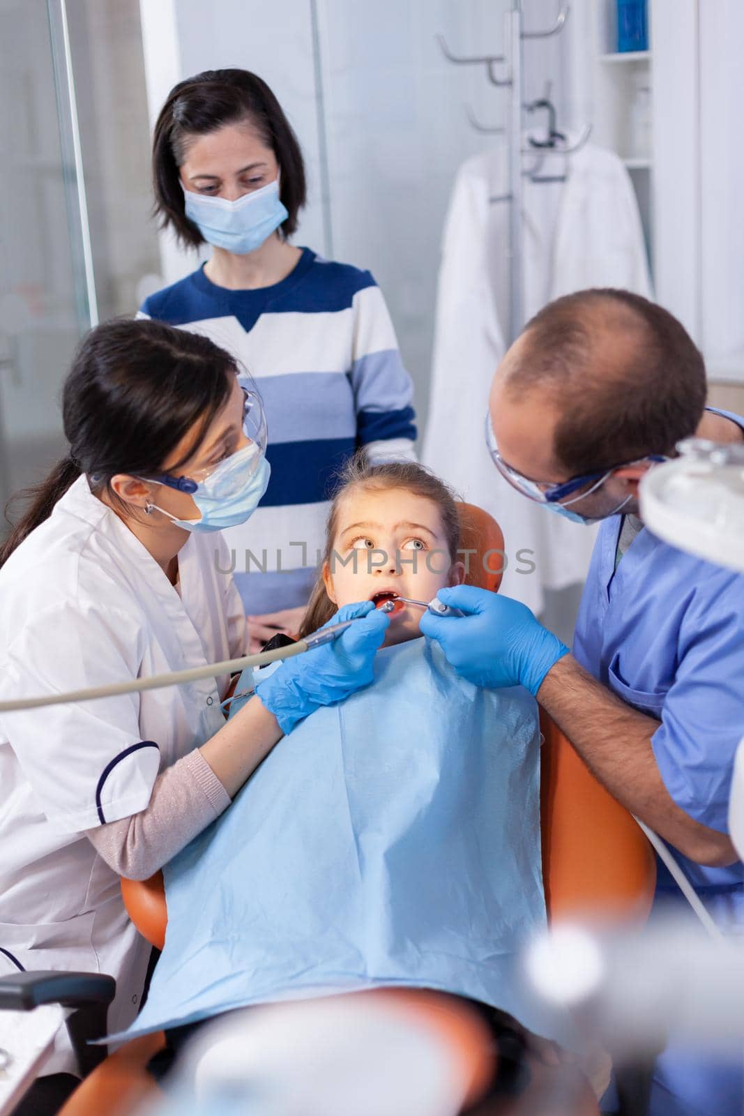 Little girl getting treatment for caries by DCStudio
