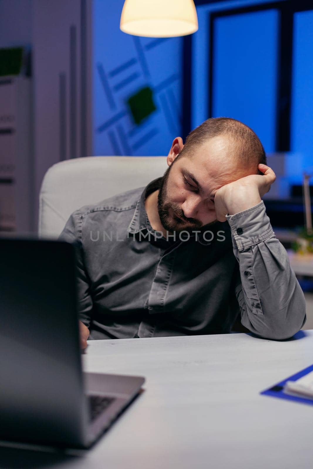 Businessman sleeping in company office by DCStudio