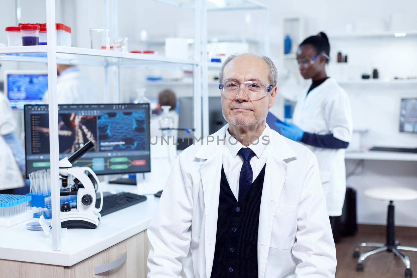 Senior male chemist looking at camera by DCStudio