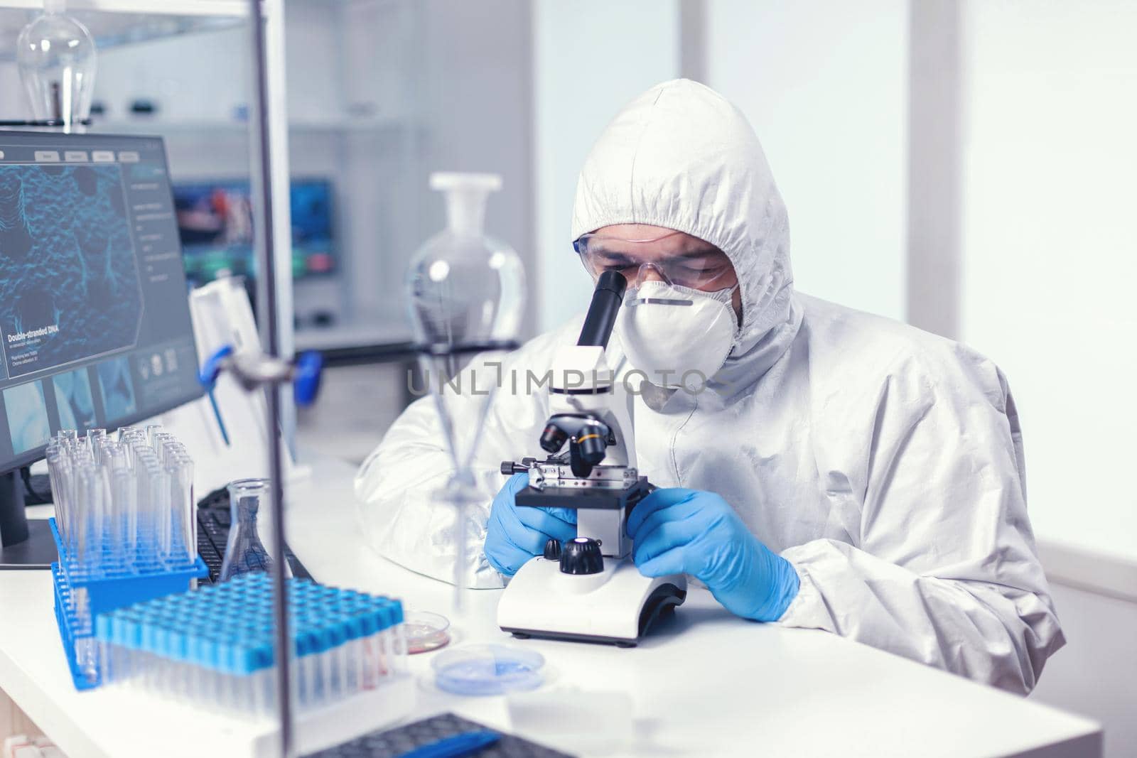 Focused scientist in medicine lab conducting experiment by DCStudio