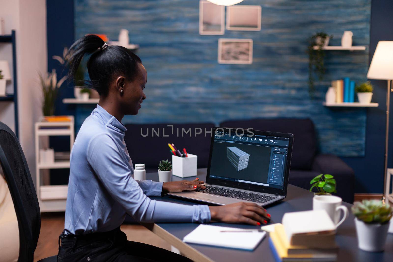 Focused dark skinned woman working on project deadline Industrial black female engineer studying prototype idea on personal computer showing software on device display