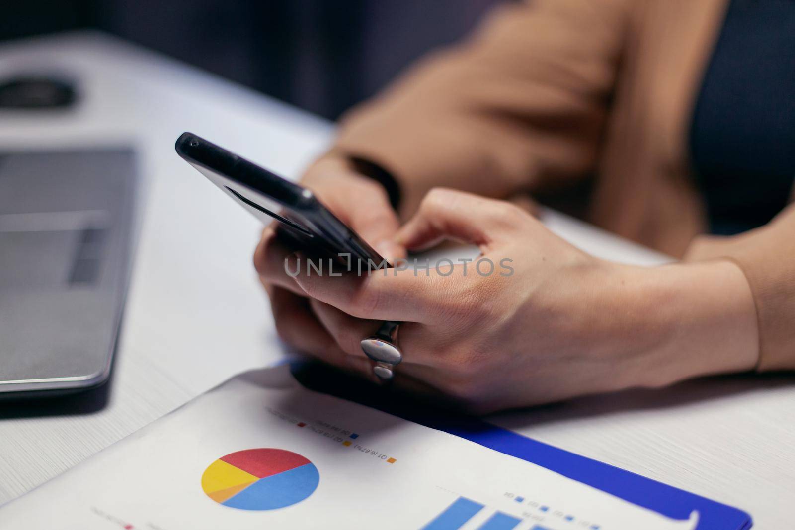 Close up of entrepreneur woman hands using smart phone by DCStudio