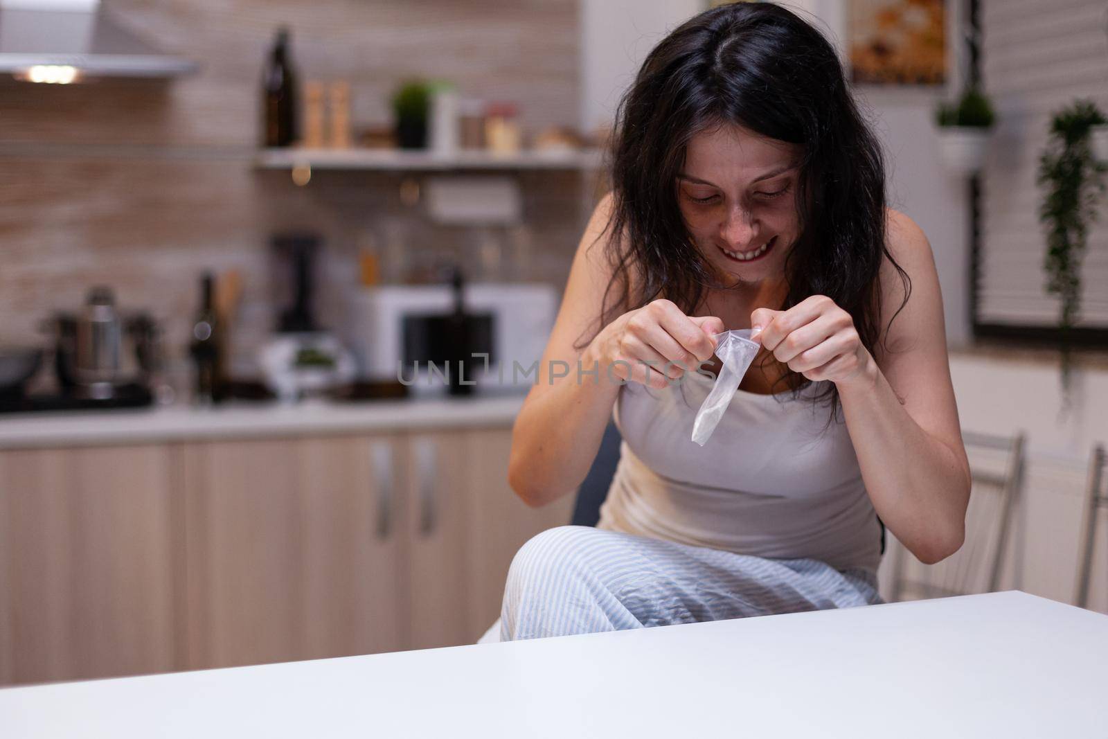 Young woman opening bag with drugs and narcotics by DCStudio