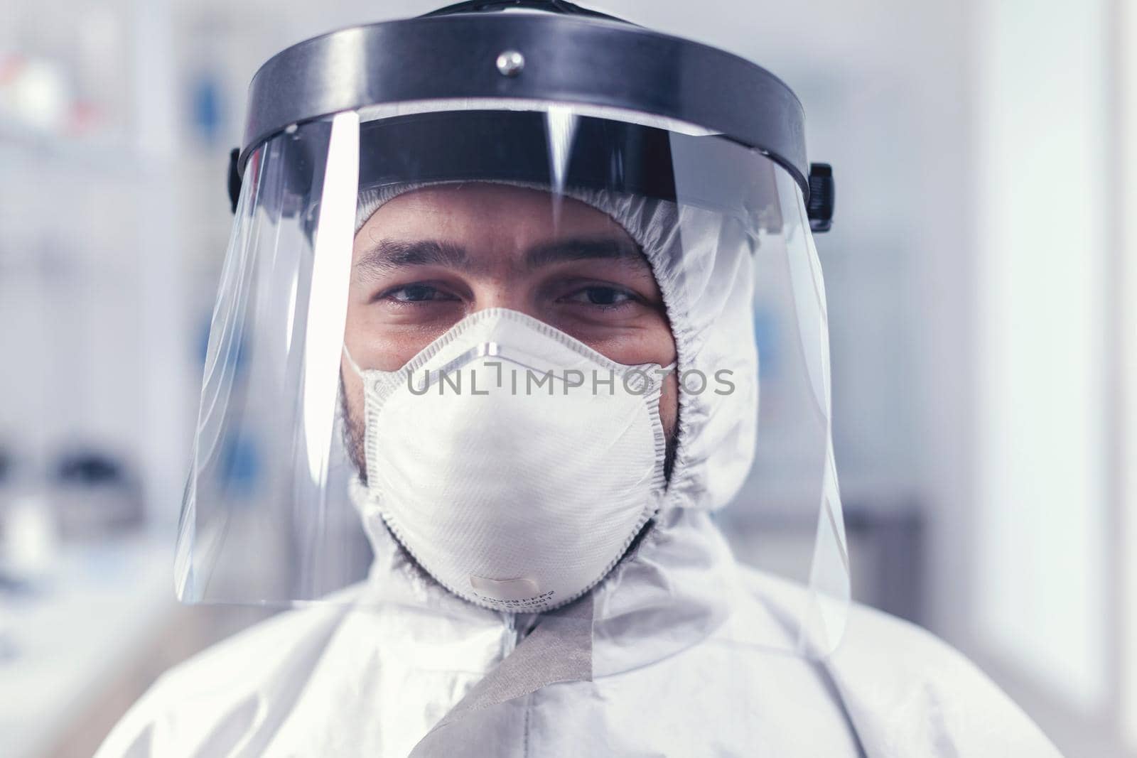 Portrait of biochemist in science laboratory wearing ppe equipment for covid19. Overworked researcher dressed in protective suit against invection with coronavirus during global epidemic.