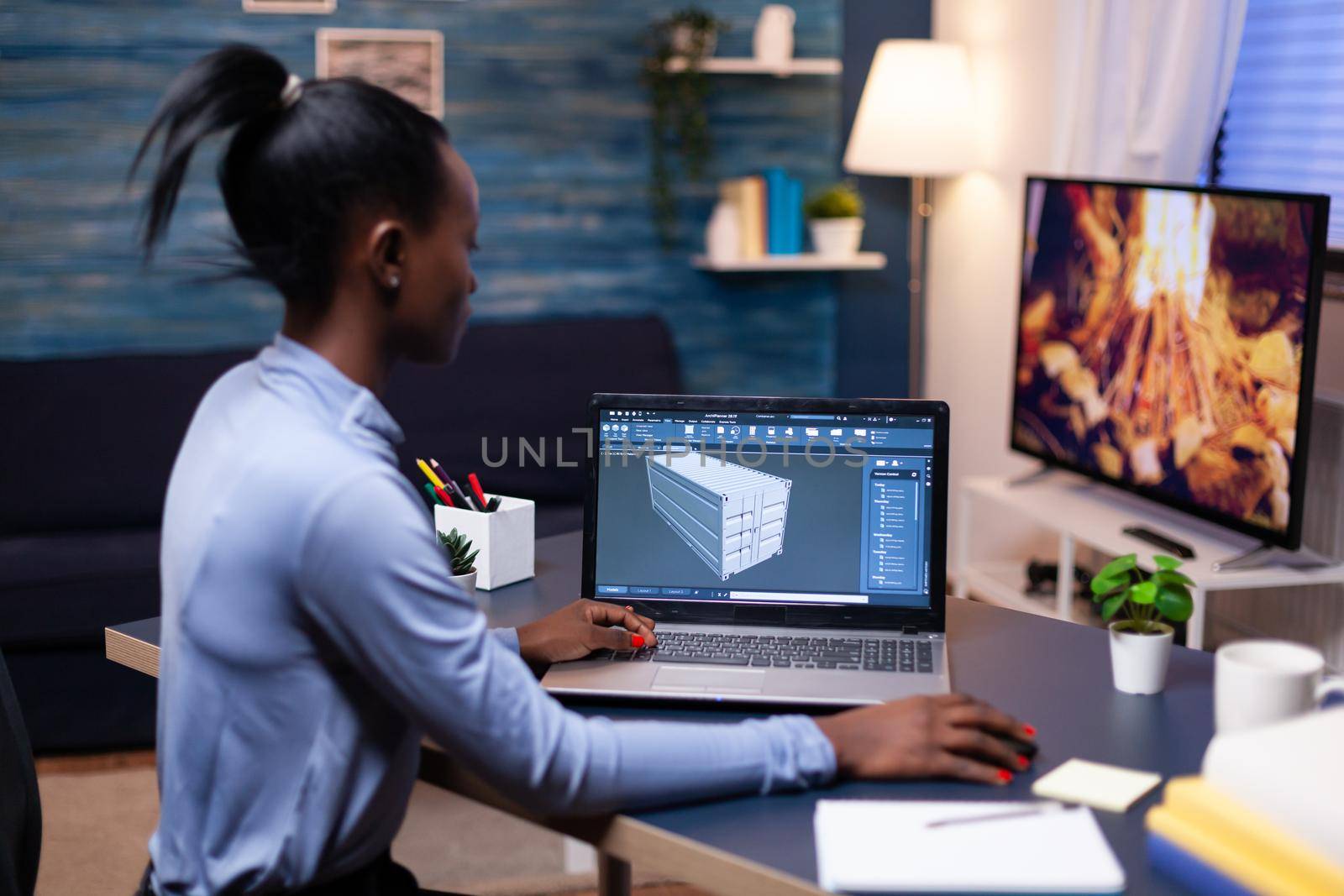 African american remote woman architect working on modern cad program overtime. Industrial black female engineer studying prototype idea on personal computer showing software on device display